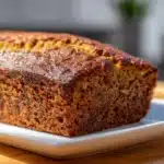 Zucchini Bread: Moist, Sweet & Perfect for Breakfast or Snacking 10 Moist zucchini bread loaf with golden crust and flecks of green zucchini