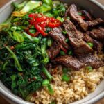 Beef & Veggie High-Protein Rice Bowl — Sliced beef with sautéed greens and brown rice.
